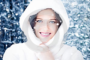 Happy holidays, lifestyle and winter fashion, beautiful woman wearing white fluffy fur coat, snowing snow in snowy