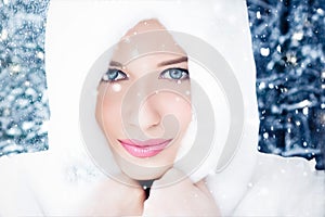 Happy holidays, lifestyle and winter fashion, beautiful woman wearing white fluffy fur coat, snowing snow in snowy