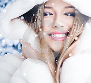 Happy holidays, lifestyle and winter fashion, beautiful woman wearing white fluffy fur coat, snowing snow in snowy