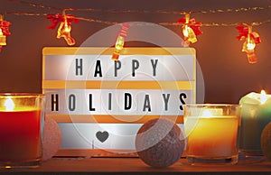 Happy holidays lightbox and Christmas decorations with candles