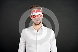 Happy holidays. Merry christmas. Man white shirt posing with photo booth props. Winter holidays. Corporate party. Santa