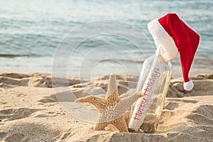 Happy Holidays message in a bottle with starfish