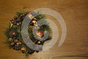 Happy Holidays and New Year. Christmas wreath with decorations on a wooden table. Retro fashion