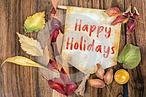 Happy holidays text with autumn theme