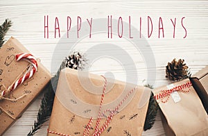 Happy Holidays text on christmas stylish presents with red ribbo