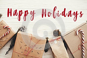 Happy Holidays text on christmas stylish presents with red ribbo