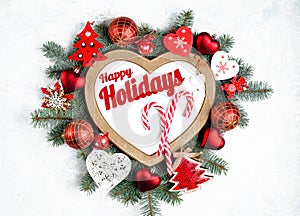 Happy Holidays Text with Holiday Evergreen Branches, frame in the shape of a heart