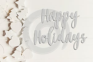 Happy holidays text, seasonal greetings card sign. minimalistic