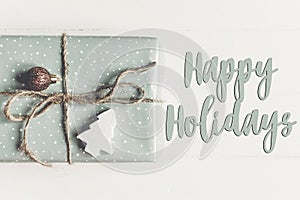 Happy holidays text, seasonal greetings card sign. modern christ