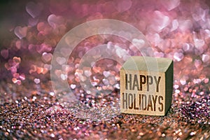 Happy holidays text with heart bokeh light