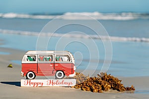 Happy Holidays VW bus sign on the shores of New Smyrna Beach, Florida