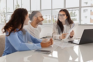 Happy Homebuyers. Spouses Having Consultation In Real Estate Agency photo