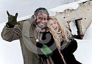 Happy homeless couple drinking