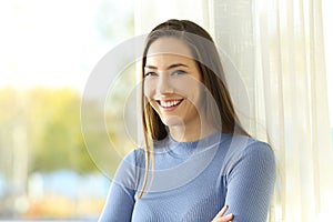 Happy homeowner looking at camera at home