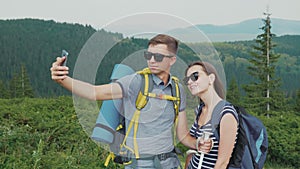 Happy Honeymoon. A young couple is photographed in the mountains, together in a hike