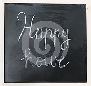 Happy hour written on a blackboard