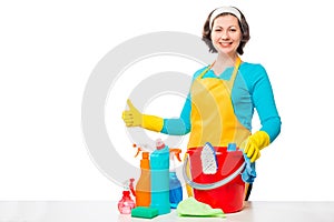 Happy housewife e and a bucket of cleaning agents