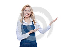happy housewife woman in apron presenting product isolated on white background