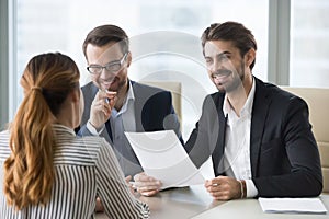 Happy hr manager with resume looking at female job seeker.