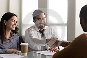 Happy hr manager welcoming african american employee at new job.