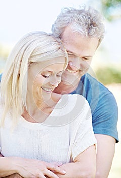 Happy, hug and senior couple in garden for bonding, relationship and commitment outdoors on weekend. Love, retirement