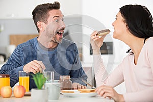 happy husband in kitchen with wife