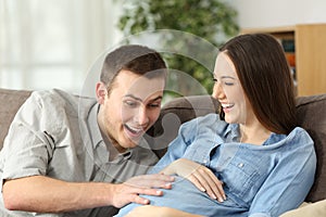 Happy husband and pregnant woman expecting birth