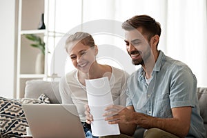 Happy husband and wife excited receiving positive bank notice