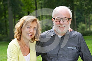 Happy husband and wife smiling outdoors