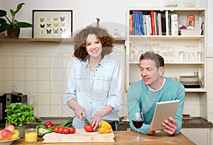 Happy husband and wife together in the kitchen