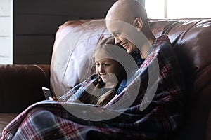 Happy ill mom and daughter kid relaxing in plaid