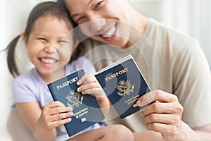 Happy immigrant family becoming new American citizens, holding US passports photo
