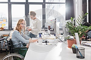 happy incapacitated person in wheelchair working