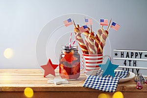 Happy Independence Day, 4th of July celebration concept with summer fresh fruit drink, twisted hot dog sausages and USA flag on