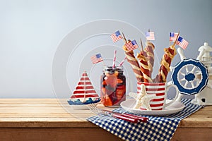 Happy Independence Day, 4th of July celebration concept with summer fresh fruit drink, twisted hot dog sausages and USA flag on