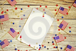 Happy Independence Day 4th july mockup with mini american flag decorated with stars and confetti. Top view