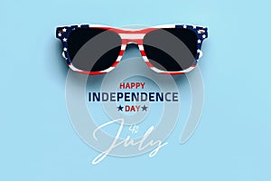 Happy Independence day July 4th. Closeup of USA flag sunglasses with text Happy Independence day July 4th