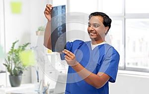 happy indian doctor or male nurse with x-ray