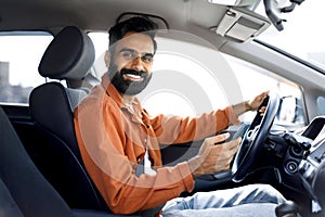 Happy Indian Driver Man Using Mobile Phone Sitting In Automobile