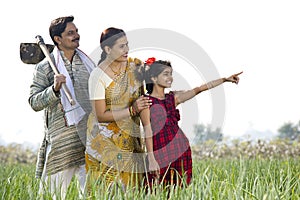 Happy Indian family in agricultural field