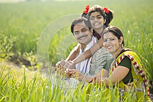 Happy Indian family in agricultural field