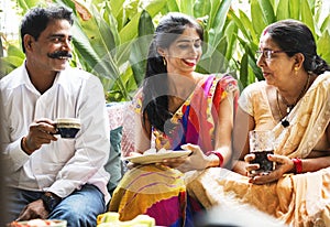 A happy Indian family having beverages together photo