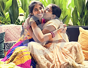 A happy Indian family hugging photo
