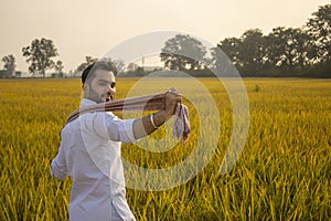 Happy Indian farmer enjoying walk in his beautiful field