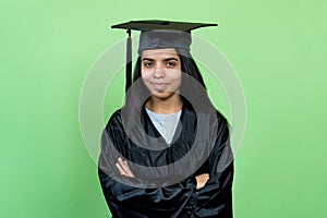 Happy indian graduate student with academic dress and hat