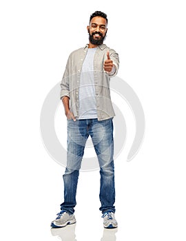 Happy indian man showing thumbs up over white