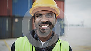 Happy Indian man working in logistic terminal of container cargo