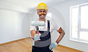 Happy indian painter or builder with paint roller