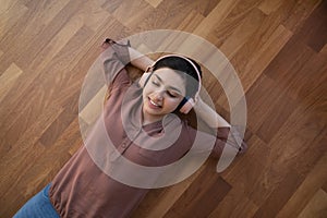 Happy Indian woman listen to music in earphones