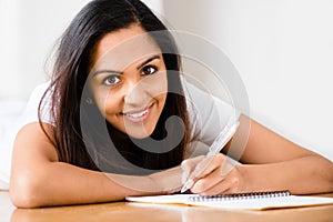 Happy Indian woman student education writing studying